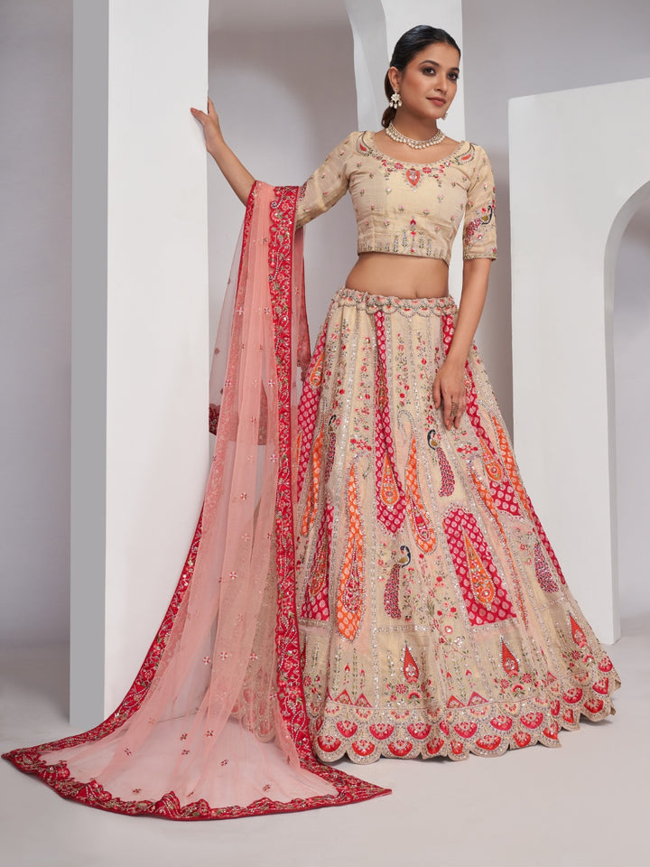 Paisley & butta embroidered lehenga choli with sequins, zari work and peach net dupatta.