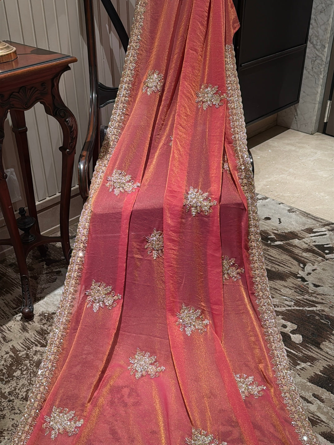 Peach-Pink Shimmer Saree with Golden Sequin Floral Motifs & Heavy Embellished Border
