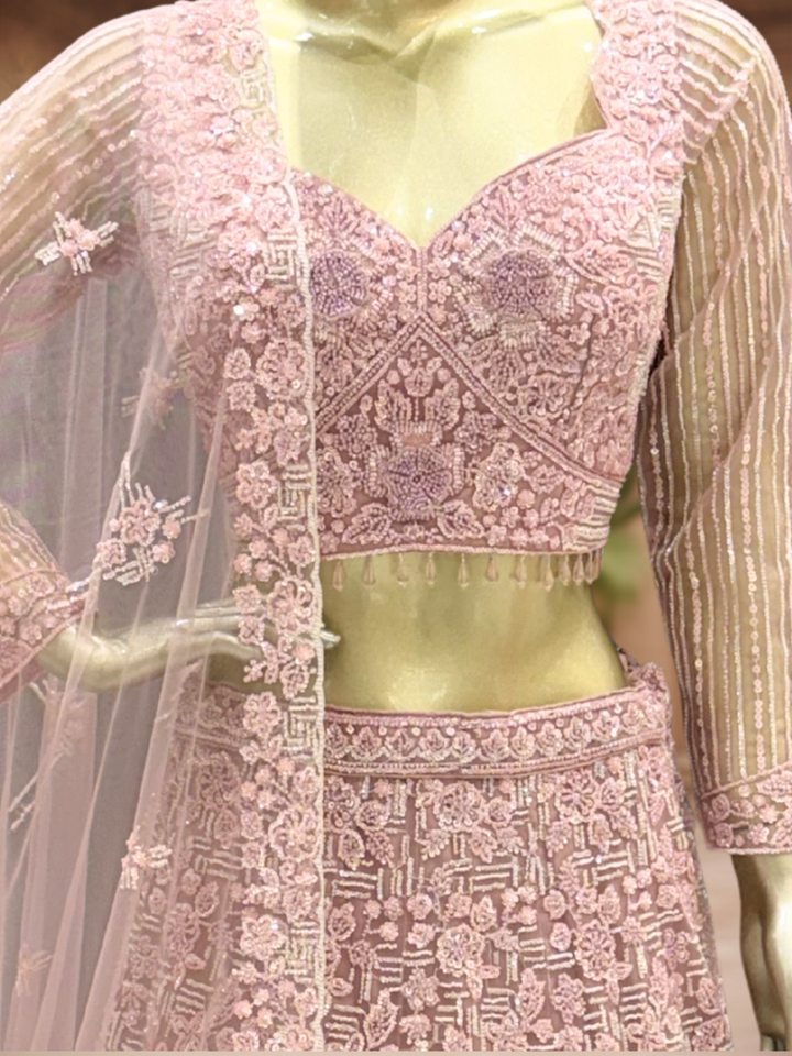 Dusty Pink Net Lehenga Choli with Heavy Resham, Cutdana & Pearl Embroidery with Sequin Striped Sleeves & Net Dupatta