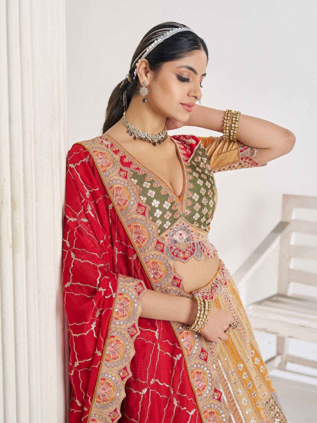 Multi-colour patchwork lehenga choli with mirror, zari & gota embroidery and bandhani dupatta.