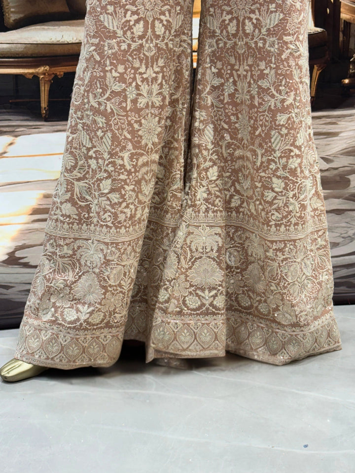 Thread embroidered kurta palazzo set with sequins and tasselled dupatta.