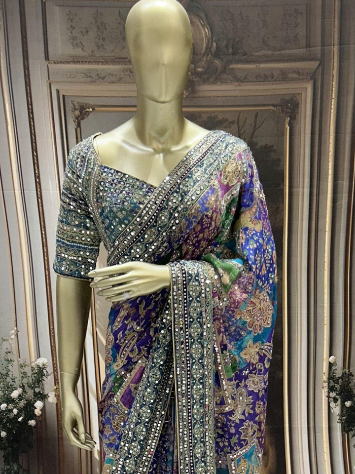 Digital-print saree with heavy mirror, stone & zari embroidered border and blouse.
