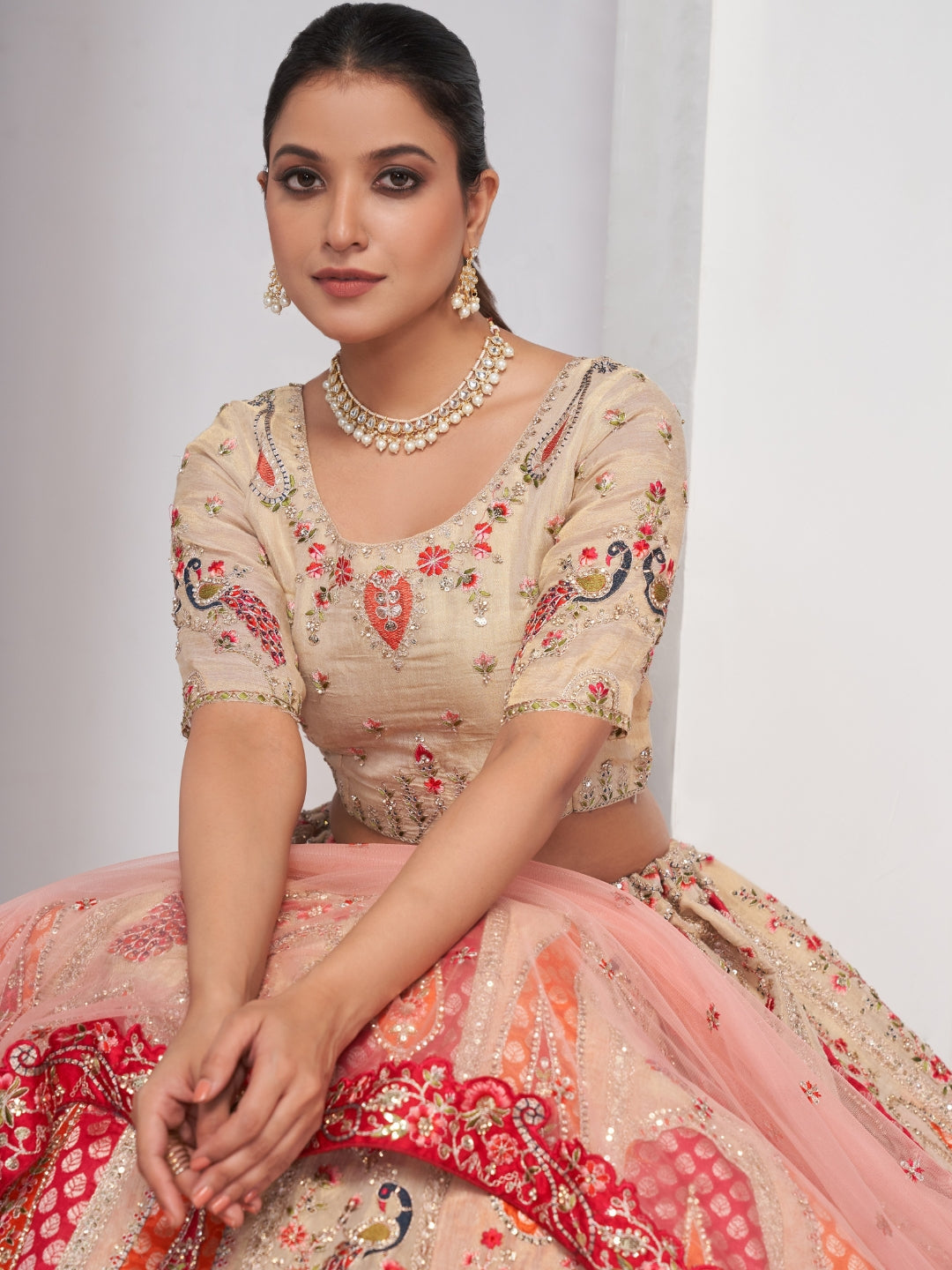 Paisley & butta embroidered lehenga choli with sequins, zari work and peach net dupatta.