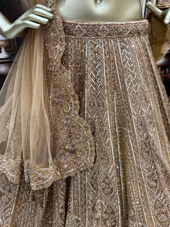 Champagne gold heavy sequin embroidered net lehenga set with scalloped border dupatta.