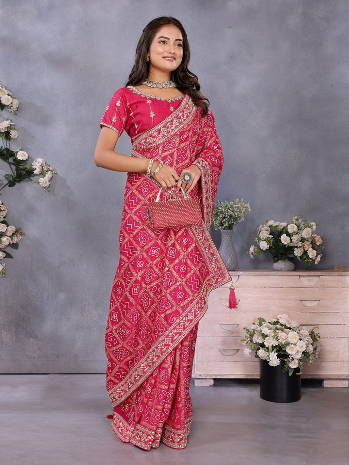 Bandhani-print saree with zari & mirror embellished border and embroidered blouse.