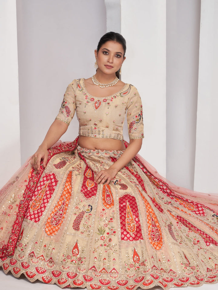 Paisley & butta embroidered lehenga choli with sequins, zari work and peach net dupatta.