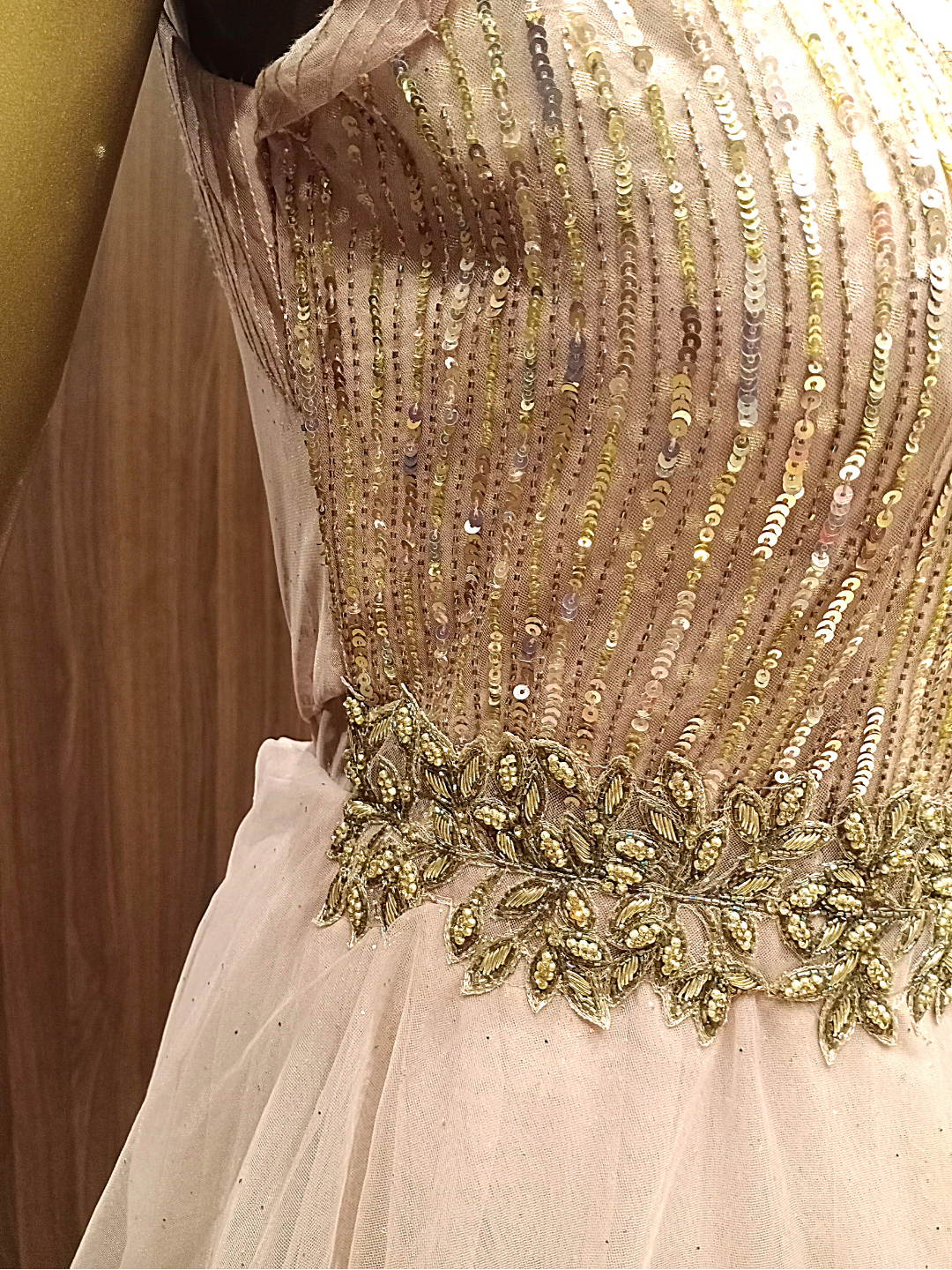 Rose Gold Flared Net Gown With Ruffled Layering & Floral Sequence Embroidery