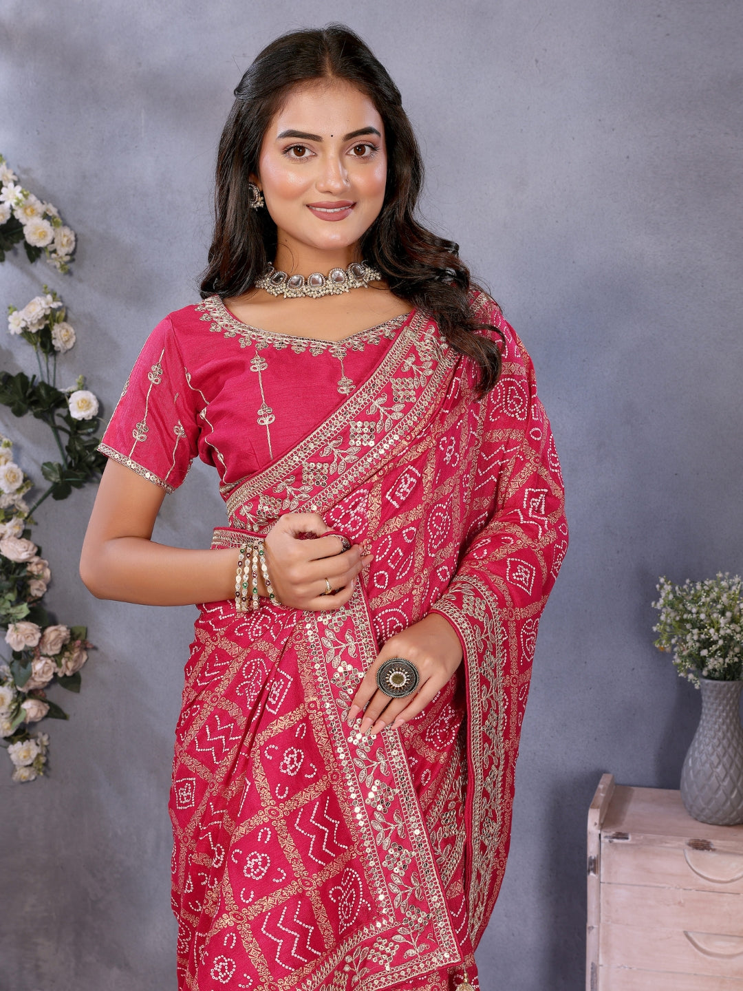 Bandhani-print saree with zari & mirror embellished border and embroidered blouse.