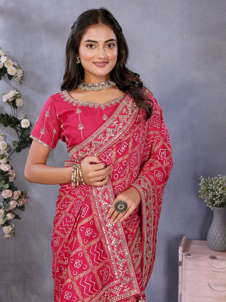 Bandhani-print saree with zari & mirror embellished border and embroidered blouse.