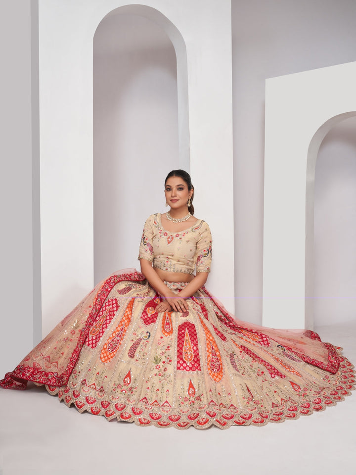 Paisley & butta embroidered lehenga choli with sequins, zari work and peach net dupatta.