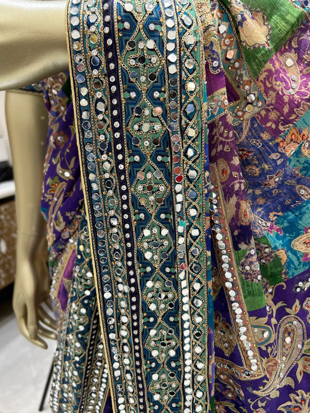 Digital-print saree with heavy mirror, stone & zari embroidered border and blouse.