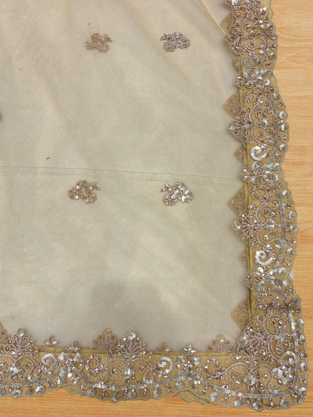 Champagne gold heavy sequin embroidered net lehenga set with scalloped border dupatta.