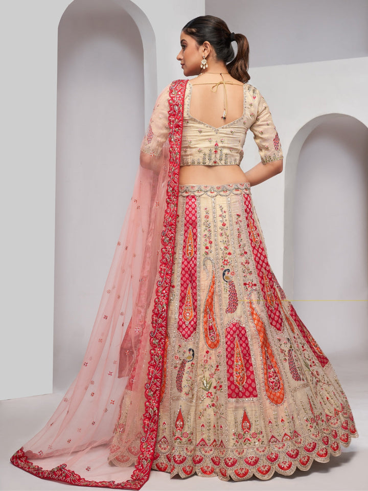Paisley & butta embroidered lehenga choli with sequins, zari work and peach net dupatta.