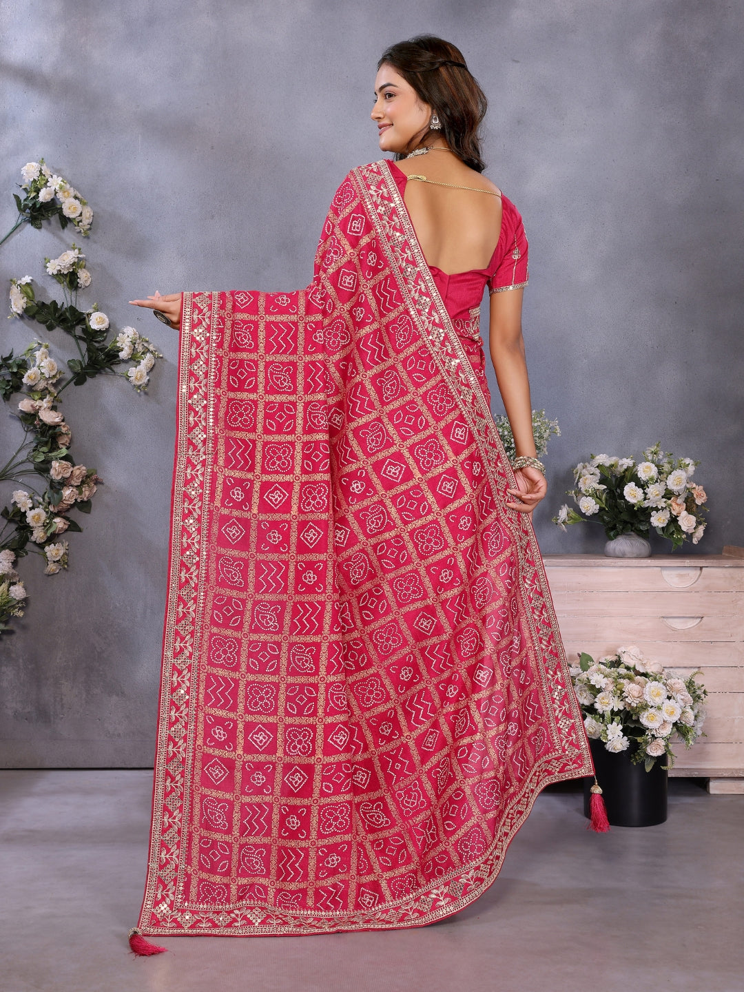 Bandhani-print saree with zari & mirror embellished border and embroidered blouse.