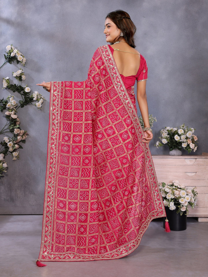 Bandhani-print saree with zari & mirror embellished border and embroidered blouse.