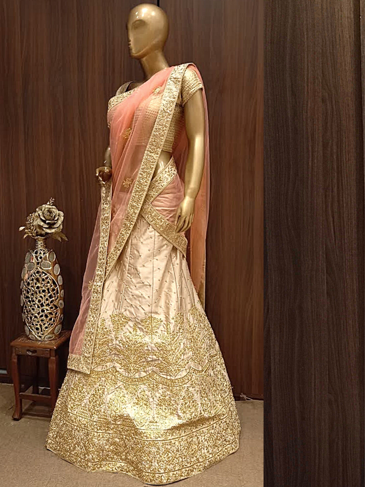 Rose Gold Semi-Stitched Silk Lehenga Set with Net Dupatta With Gold Aari Embroidery