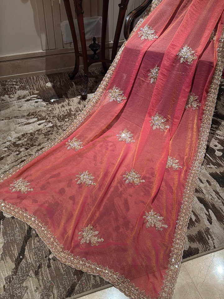 Peach-Pink Shimmer Saree with Golden Sequin Floral Motifs & Heavy Embellished Border