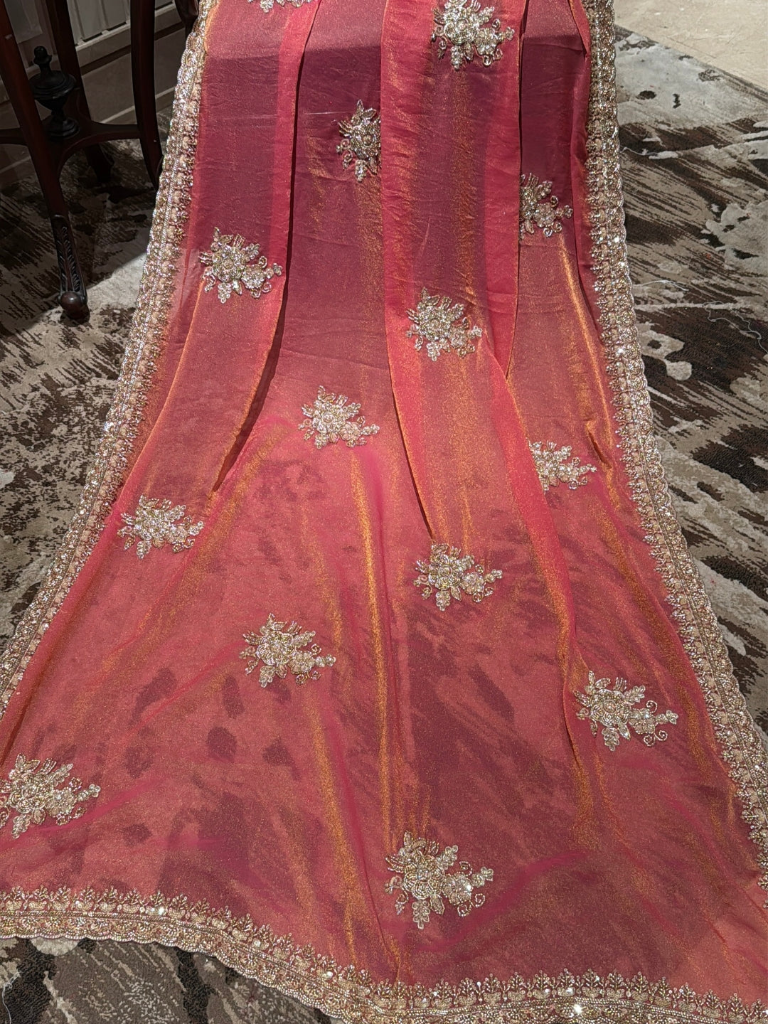 Peach-Pink Shimmer Saree with Golden Sequin Floral Motifs & Heavy Embellished Border
