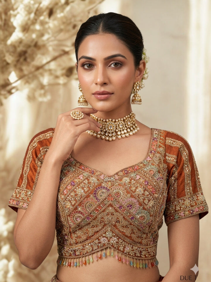 Rust Brown Crepe Lehenga Choli with Heavy Resham & Zari Embroidered Blouse, Tassel Hem & Embroidered Border