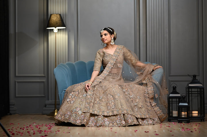 Bridal Gold lehenga with Zardozi, kundan, and Resham embroidery.