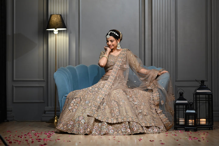 Bridal Gold lehenga with Zardozi, kundan, and Resham embroidery.