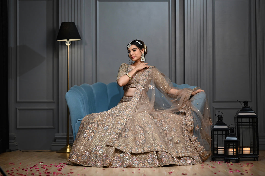 Bridal Gold lehenga with Zardozi, kundan, and Resham embroidery.