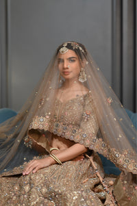 Bridal Gold lehenga with Zardozi, kundan, and Resham embroidery.