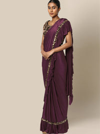 Chhabra 555 Ruffled Pre-Draped Ready to Wear Saree with Golden Sequence Embellishments

Color: Purple & Black

Type: Ruffled Sarees

Pattern: Embellished

Ornamentation: Sequinned

Border: Embellished

Fabric: Viscose Rayon

Pre-stitched saree. Saree fabric length: 5.5 meter, Width: 1.10 mtr, Choli length - 15 inches
Dry Clean Only

The CAD image gives a detailed look of the actual blouse piece that comes with this saree. The blouse used by the model in the pictures is only for styling purpose.