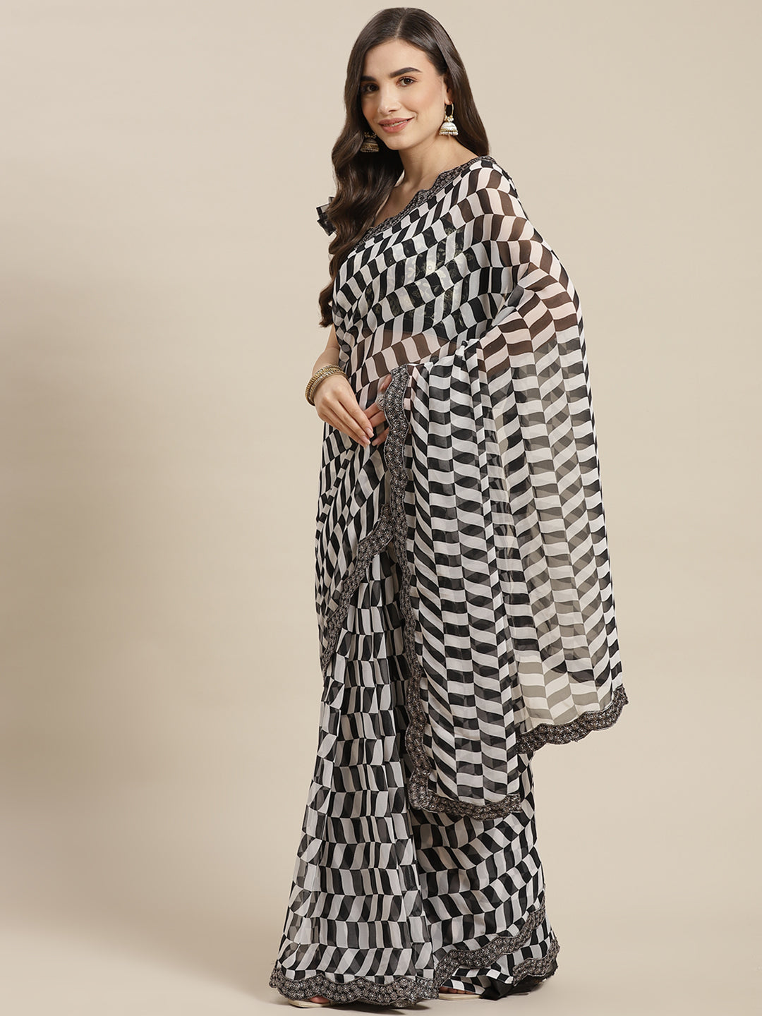 Chhabra 555 Black & White Printed Geometerical Georgette Embellished Saree with Scalloped border

Color: Black & White

Type: Leheriya Sarees

Pattern: Printed

Pattern Type: Geometric

Ornamentation: Sequinned

Border: Embroidered

Fabric: Georgette

Saree length: 5.40 mtr., Width: 1.10 mtr, Blouse length: 0.70 mtr
Dry Clean Only

The CAD image gives a detailed look of the actual blouse piece that comes with this saree. The blouse used by the model in the pictures is only for styling purpose.