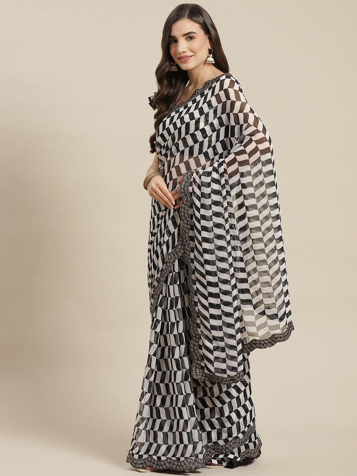 Chhabra 555 Black & White Printed Geometerical Georgette Embellished Saree with Scalloped border

Color: Black & White

Type: Leheriya Sarees

Pattern: Printed

Pattern Type: Geometric

Ornamentation: Sequinned

Border: Embroidered

Fabric: Georgette

Saree length: 5.40 mtr., Width: 1.10 mtr, Blouse length: 0.70 mtr
Dry Clean Only

The CAD image gives a detailed look of the actual blouse piece that comes with this saree. The blouse used by the model in the pictures is only for styling purpose.