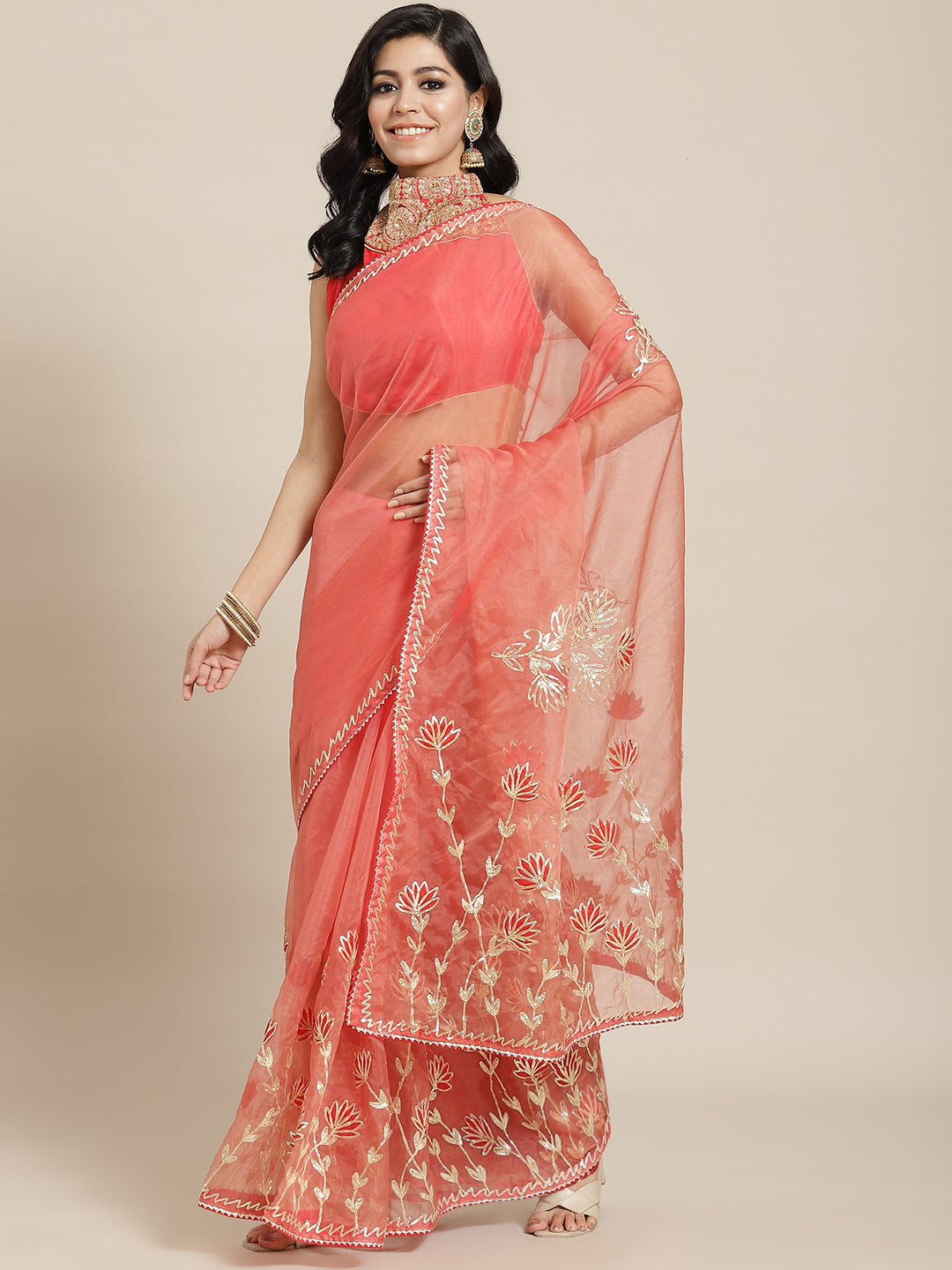 Chhabra 555 Coral Organza Jaipuri Saree with Gota Patti & Resham Embroidery and Contrast Blouse

Color: Coral

Type: NA Sarees

Pattern: Embellished

Pattern Type: Floral

Ornamentation: Gotta Patti

Border: Embroidered

Fabric: Organza

Saree length: 5.40 mtr., Width: 1.10 mtr, Blouse length: 0.70 mtr
Dry Clean only

The CAD image gives a detailed look of the actual blouse piece that comes with this saree. The blouse used by the model in the pictures is only for styling purpose.
