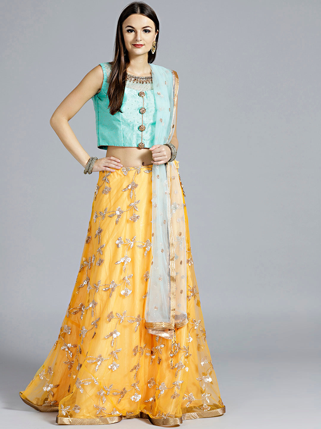 Chhabra 555 Mustard Yellow Contemporary Lehenga with sequin embroidery in floral patterns and contrast teal Dupatta and blouse with hand embroidery
