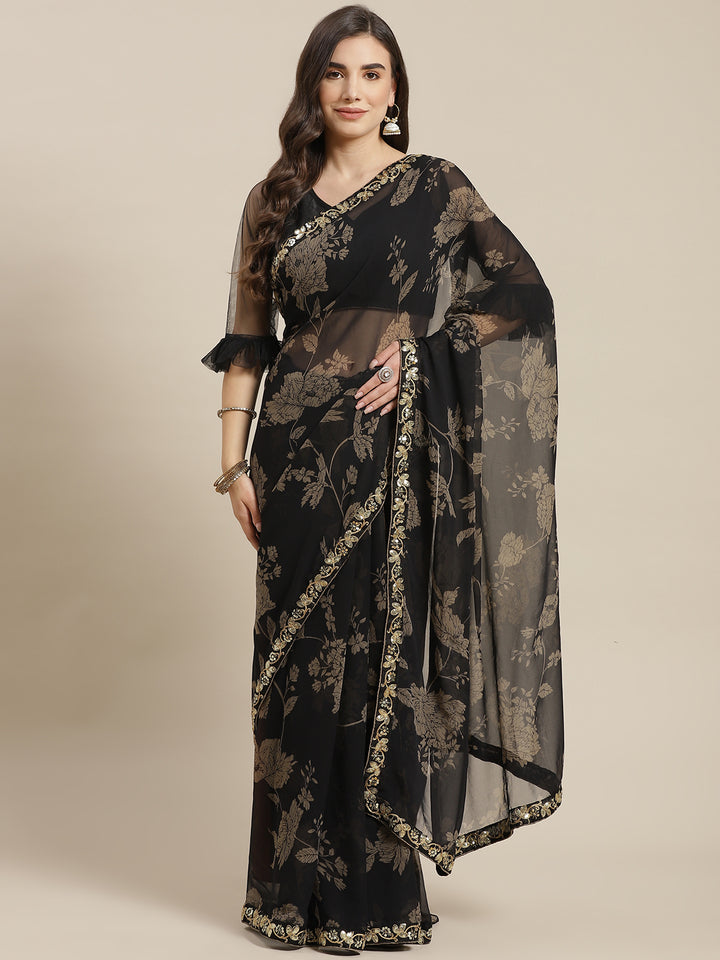 Chhabra 555 Metallic Floral Print Georgette Saree with Sequin & Mirror Embroidery Border 

Color: Black

Type: NA Sarees

Pattern: Printed

Pattern Type: Floral

Ornamentation: Sequinned

Border: Embroidered

Fabric: Georgette

Saree length: 5.40 mtr., Width: 1.10 mtr, Blouse length: 0.70 mtr
Dry Clean Only

The CAD image gives a detailed look of the actual blouse piece that comes with this saree. The blouse used by the model in the pictures is only for styling purpose.