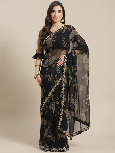 Chhabra 555 Metallic Floral Print Georgette Saree with Sequin & Mirror Embroidery Border 

Color: Black

Type: NA Sarees

Pattern: Printed

Pattern Type: Floral

Ornamentation: Sequinned

Border: Embroidered

Fabric: Poly Georgette

Saree length: 5.40 mtr., Width: 1.10 mtr, Blouse length: 0.70 mtr
Dry Clean Only

The CAD image gives a detailed look of the actual blouse piece that comes with this saree. The blouse used by the model in the pictures is only for styling purpose.