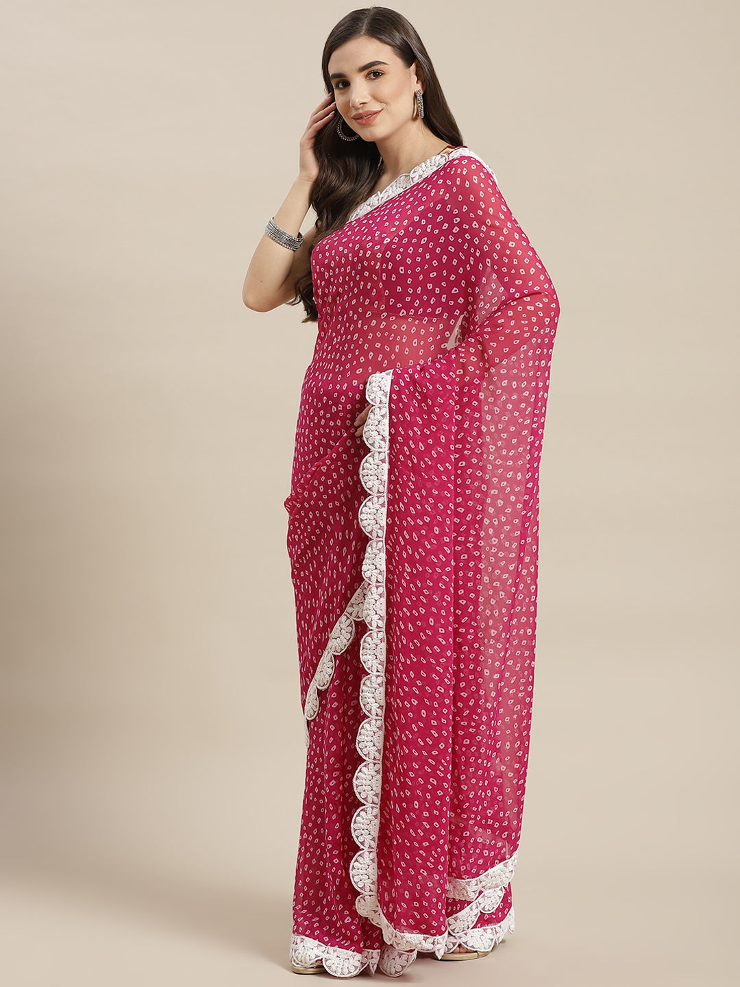 Chhabra 555 Magenta Bandhani Print Georgette Saree with Resham Embroidered Scalloped Border

Color: Magenta

Type: Bandhani Sarees

Pattern: Embroidered

Pattern Type: Bandhani

Ornamentation: Embroidered

Border: Embroidered

Fabric: Georgette

Saree length: 5.40 mtr., Width: 1.10 mtr, Blouse length: 0.80 mtr
Dry Clean Only

The CAD image gives a detailed look of the actual blouse piece that comes with this saree. The blouse used by the model in the pictures is only for styling purpose.