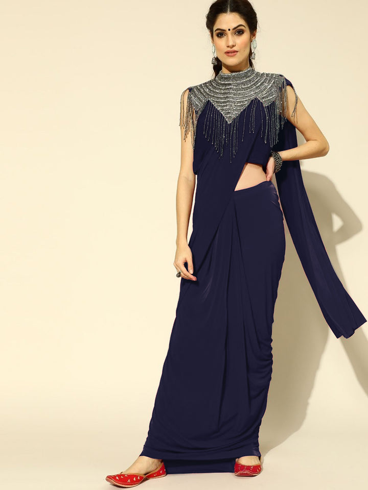 Chhabra 555 Ruffled Pre-Draped Ready to Wear Saree with Tribal Embellished Necklace with Tassles

Color: Navy Blue

Type: Ruffled Sarees

Pattern: Embellished

Pattern Type: Solid

Ornamentation: Beads and Stones

Fabric: Viscose Rayon

Pre-stitched saree. Saree fabric length: 5.5 meter, Width: 1.10 mtr, Choli length - 15 inches
Dryclean Only

The CAD image gives a detailed look of the actual blouse piece that comes with this saree. The blouse used by the model in the pictures is only for styling purpose.