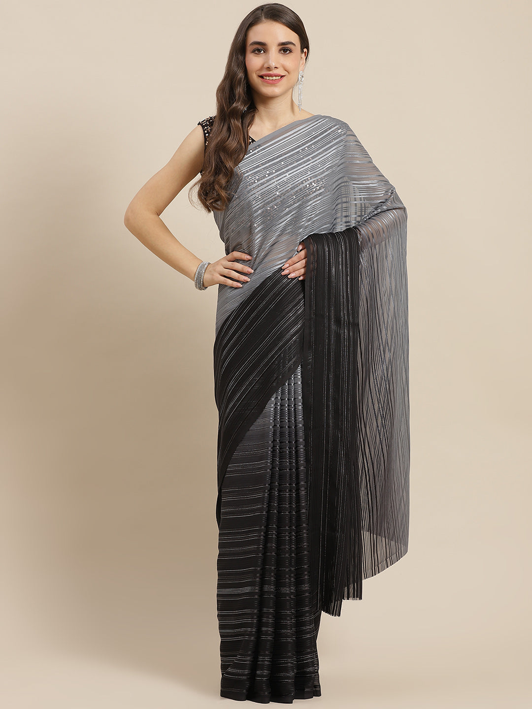 Chhabra 555 Black Ombre Georgette Satin & Lurex Woven Saree With Sequence Embellished Metalic Blouse

Color: Black

Type: NA Sarees

Pattern: Embellished

Pattern Type: Ombre

Ornamentation: Sequinned

Border: No Border

Fabric: Georgette

Saree length: 5.40 mtr., Width: 1.10 mtr, Blouse length: 0.70 mtr
Dry Clean

The CAD image gives a detailed look of the actual blouse piece that comes with this saree. The blouse used by the model in the pictures is only for styling purpose.