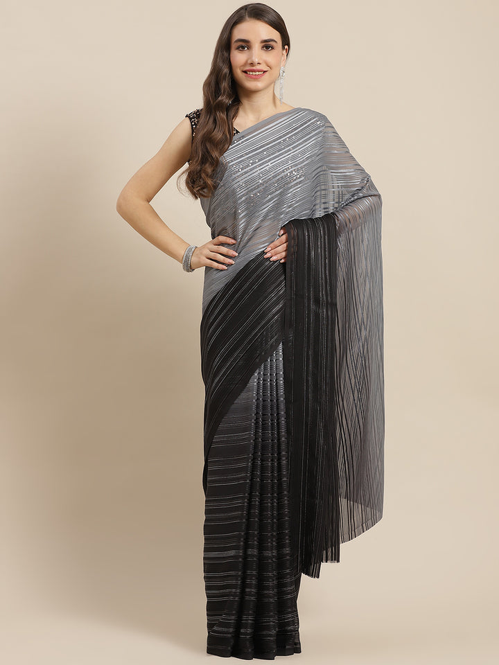 Chhabra 555 Black Ombre Georgette Satin & Lurex Woven Saree With Sequence Embellished Metalic Blouse

Color: Black

Type: NA Sarees

Pattern: Embellished

Pattern Type: Ombre

Ornamentation: Sequinned

Border: No Border

Fabric: Georgette

Saree length: 5.40 mtr., Width: 1.10 mtr, Blouse length: 0.70 mtr
Dry Clean

The CAD image gives a detailed look of the actual blouse piece that comes with this saree. The blouse used by the model in the pictures is only for styling purpose.