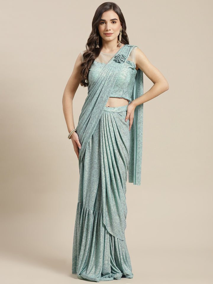 Chhabra 555 Ruffled Pre-Stitched Draped Mint Green Shimmer Georgette Embellished Pleated Saree

Color: Sea Green

Type: NA Sarees

Pattern: Printed

Pattern Type: Abstract

Ornamentation: Embroidered

Border: No Border

Fabric: Georgette

Saree length: 5.50 mtr., Width: 1.10 mtr, Blouse Height: 16 inches
Dry Clean only

The CAD image gives a detailed look of the actual blouse piece that comes with this saree. The blouse used by the model in the pictures is only for styling purpose.