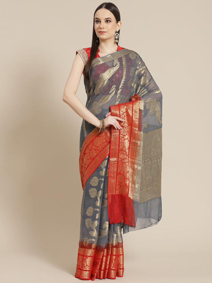 Chhabra 555 Grey Red Ombre Mysore Georgette Handwoven Saree with Peacock Motifs 

Color: Grey

Type: NA Sarees

Pattern: Woven Design

Pattern Type: Woven Design

Ornamentation: NA

Border: Woven Design

Fabric: Georgette

Saree length: 5.70 mtr., Width: 1.10 mtr, Blouse length: 0.80 mtr
Dry Clean only

The CAD image gives a detailed look of the actual blouse piece that comes with this saree. The blouse used by the model in the pictures is only for styling purpose.