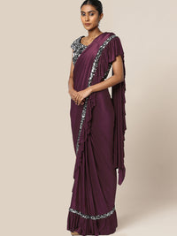 Chhabra 555 Ruffled Pre-Draped Ready to Wear Saree with SIlver Sequence Embellishments

Color: Purple & Black

Type: Ruffled Sarees

Pattern: Embellished

Ornamentation: Sequinned

Border: Embellished

Fabric: Viscose Rayon

Pre-stitched saree. Saree fabric length: 5.5 meter, Width: 1.10 mtr, Choli length - 15 inches
Dry Clean Only

The CAD image gives a detailed look of the actual blouse piece that comes with this saree. The blouse used by the model in the pictures is only for styling purpose.