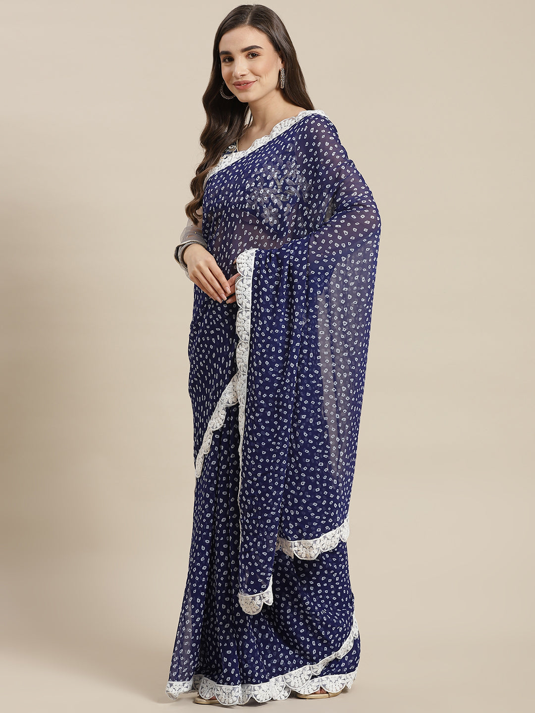 Chhabra 555 Indigo Bandhani Print Georgette Saree with Embroidered Scalloped Border & Belt

Color: Indigo Blue

Type: Bandhani Sarees

Pattern: Embroidered

Pattern Type: Bandhani

Ornamentation: Embroidered

Border: Embroidered

Fabric: Georgette

Saree length: 5.40 mtr., Width: 1.10 mtr, Blouse length: 0.80 mtr
Dry Clean Only

The CAD image gives a detailed look of the actual blouse piece that comes with this saree. The blouse used by the model in the pictures is only for styling purpose.