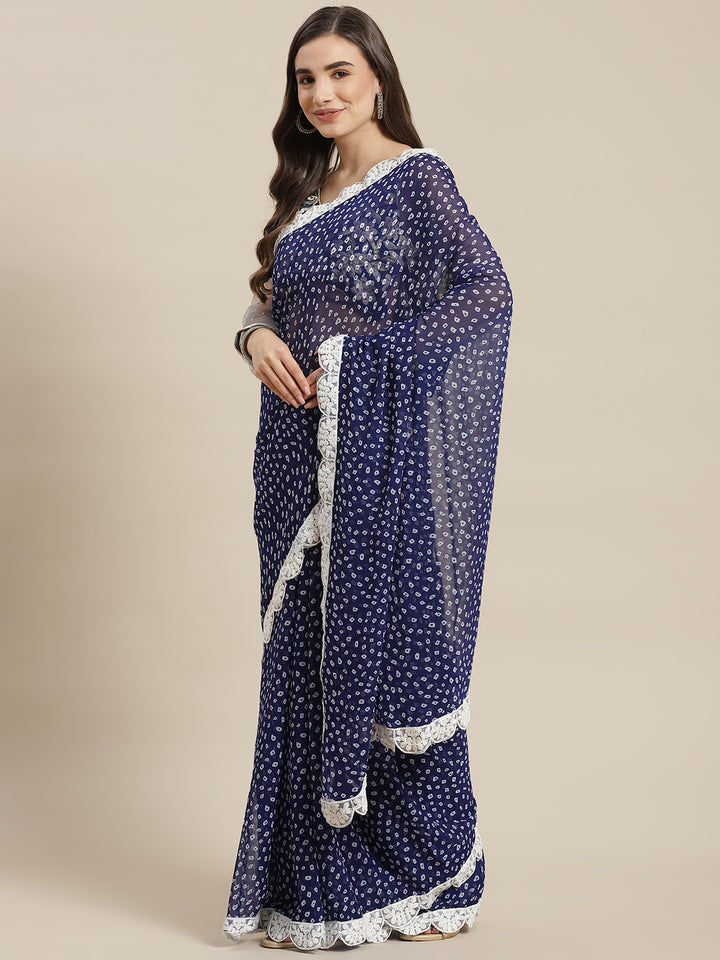 Chhabra 555 Indigo Bandhani Print Georgette Saree with Embroidered Scalloped Border & Belt

Color: Indigo Blue

Type: Bandhani Sarees

Pattern: Embroidered

Pattern Type: Bandhani

Ornamentation: Embroidered

Border: Embroidered

Fabric: Georgette

Saree length: 5.40 mtr., Width: 1.10 mtr, Blouse length: 0.80 mtr
Dry Clean Only

The CAD image gives a detailed look of the actual blouse piece that comes with this saree. The blouse used by the model in the pictures is only for styling purpose.